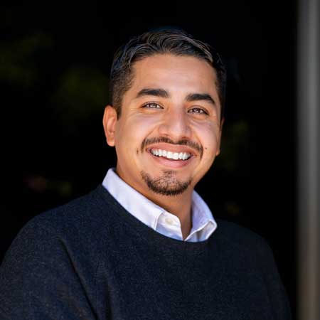 Headshot of Edgar Montanez, Senior Account. Shot in a professional office ambiance in Sacramento, Edgar's steady and assured expression underscores his extensive experience and capability in managing major accounts for the company