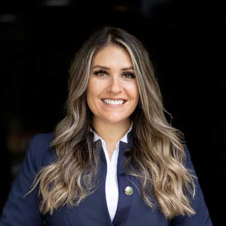 Headshot of Rebecca Story, Director of Property Management. Set against an elegant office backdrop in Sacramento, Rebecca's confident and attentive expression emphasizes her critical role in overseeing and ensuring the optimal management of properties under the company's portfolio