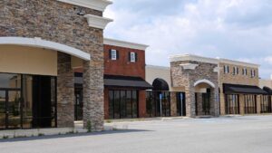 A commercial retail strip, representing the importance of understanding owner goals and objectives in commercial real estate property management. Capital Rivers ensures clear communication and strategic planning for value enhancement and tenant relationship management.