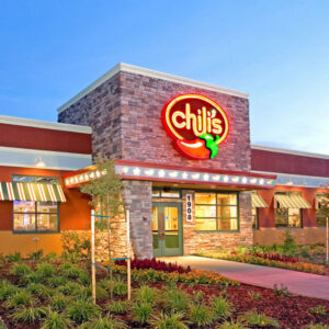 Chili's restaurant in Sacramento bathed in the warm glow of its lights during evening hours. This prominent location reflects the proficiency of Capital Rivers Commercial in the commercial real estate sector, highlighting their adeptness at pairing renowned brands with ideal locations