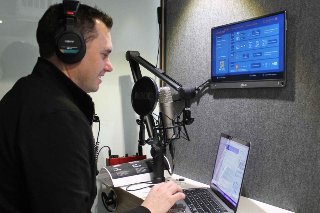 Image of Greg Aguirre, CEO of Capital Rivers Commercial, in a podcast booth, engaging in a deep conversation with Chris Gallardo about the future of entertainment and the rise of inland surfing experiences. The setting reflects the excitement and innovation surrounding this new wave in entertainment activity.