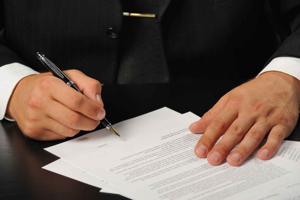 A broker signing a Subordination, Non-disturbance, and Attornment Agreement (SNDA), a critical document in commercial real estate transactions, ensuring stability and protection for tenants and lenders during financial shifts, as highlighted by Capital Rivers Commercial's expertise