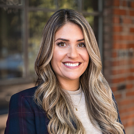 Headshot of Rebecca Story, Director of Property Management. Set against an elegant office backdrop in Sacramento, Rebecca's confident and attentive expression emphasizes her critical role in overseeing and ensuring the optimal management of properties under the company's portfolio.