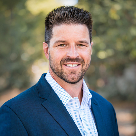 Headshot of Ryan Orn, Vice President of Brokerage. Positioned in a polished office backdrop in Sacramento, Ryan's composed expression exudes expertise and dedication, symbolizing his significant role in directing brokerage activities.