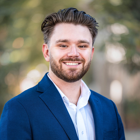 Headshot of Danny Arroyo, Director of Sales & Leasing in the commercial real estate sector, proudly serving Sacramento, California. Set against a professional office setting, Danny's determined and confident expression showcases his command over the intricate dynamics of commercial real estate in both Sacramento and the wider California region