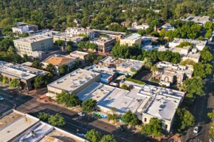 This image shows an arial of downtown Chico, CA and this article offers an overview of current commercial properties available in Chico and highlights the benefits of investing in this city, with a particular focus on Chico commercial sales.