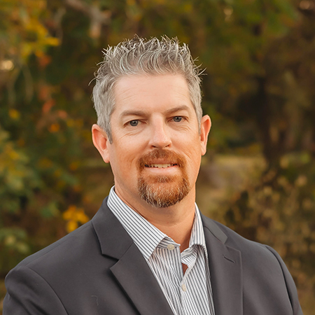 A headshot of Matthew Tate, Executive Vice President who brings 15 years of experience at the intersection of the public and private sectors to his role at Capital Rivers Connect.