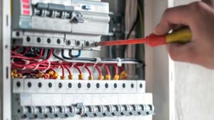 Electrician working on commercial electrical panel