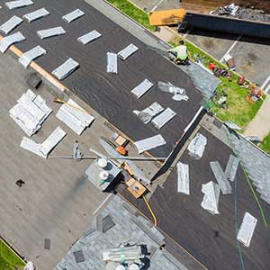 Worker replacing roof preparing your property for the winter season