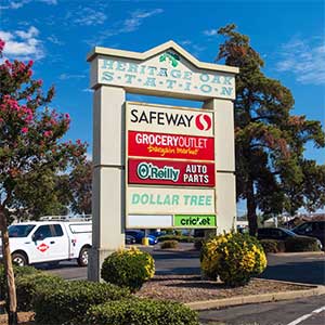 Monument sign for Safeway, Grocery Outlet, and other retailers illustrating retail agglomeration in a neighborhood center