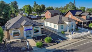 Two commercial retail buildings with landscaped grounds, illustrating the best commercial property investment opportunities in Northern California.