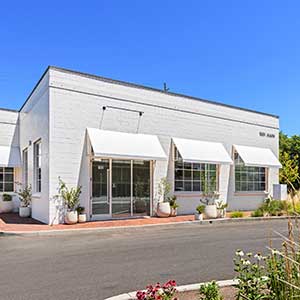 Modern commercial retail building with storefront windows, representing the best commercial property investment for owner-users and investors.