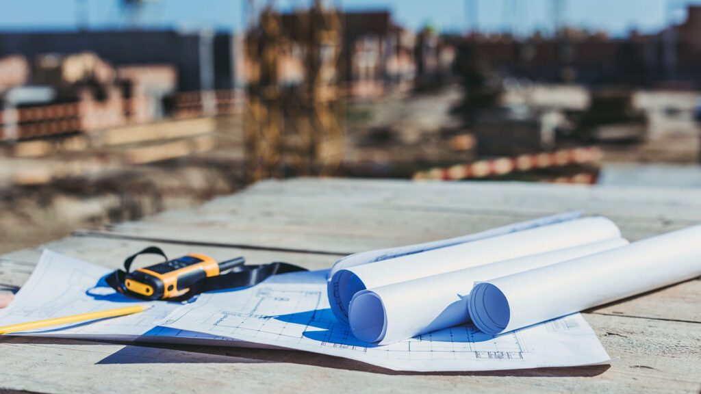PACE facility development site with blueprints