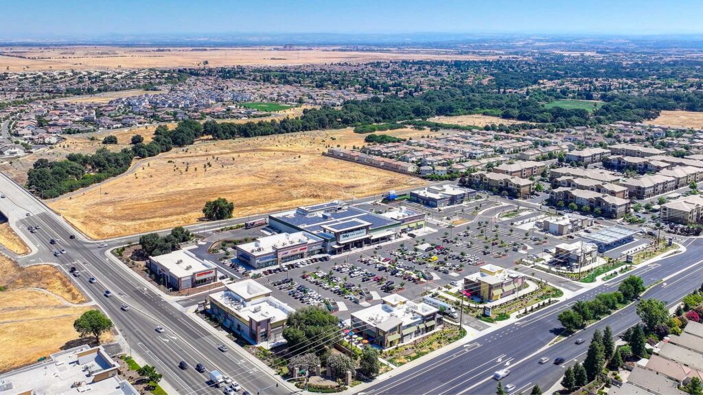 Aerial view of a retail shopping center surrounded by residential development in the Sacramento suburbs.