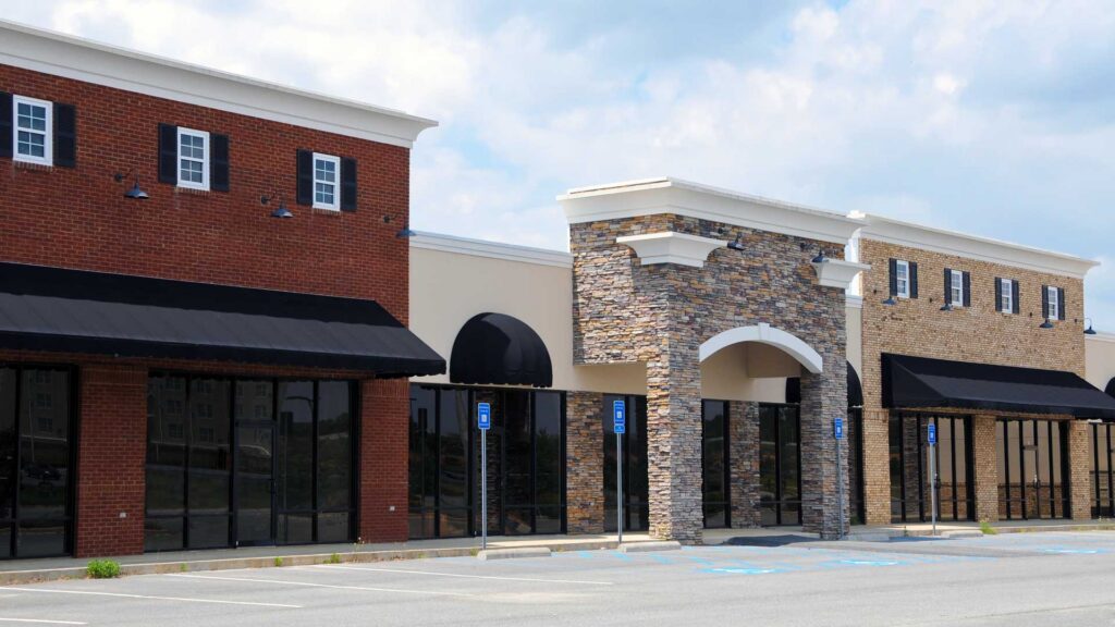 Vacant retail storefronts and parking area illustrating commercial property leasing and available commercial space.