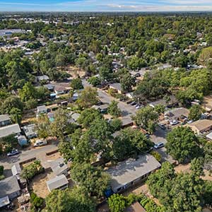 Aerial view of a tree-lined residential neighborhood in Chico, California, showing existing homes and areas relevant to Chico housing development.