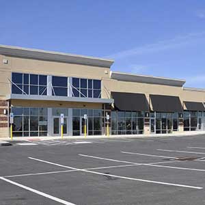 Commercial property asset management for a retail center with storefronts and parking.