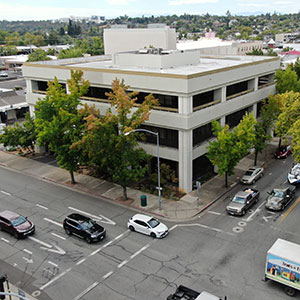 Aerial view of the existing three-story Downtown Redding office and retail building at 1700 Pine Street, located at the corner of Pine and Placer Streets.