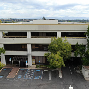 Existing three-story Downtown Redding office and retail building at 1700 Pine Street, showing the entrance, parking area, and exterior before renovations.