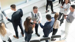 Attendees networking and shaking hands at a National PACE Association conference.