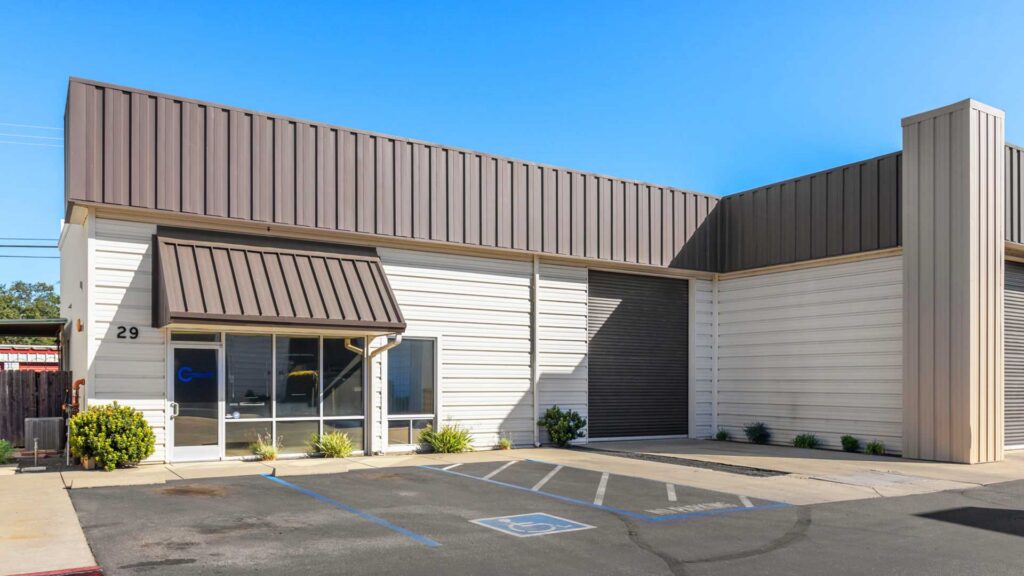 Northern California commercial real estate market featuring an industrial warehouse with office space and a roll-up loading door in Chico, California.