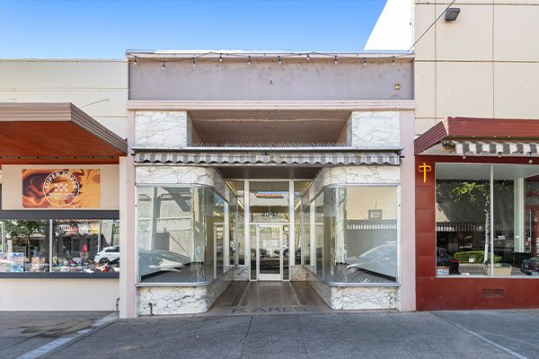 2041 Bird Street is a ±1,882 SF historic two-unit commercial building with large street-facing display windows in downtown Oroville, California.