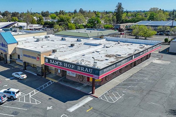 Image of Former Sam’s Hof Brau in cold shell condition located at high-trafficked intersection.