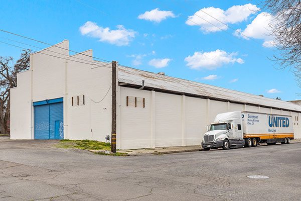 Image of a Chico industrial property that spans an entire city block and includes a ±20,000 square feet metal warehouse with ±1,200 square feet of air-conditioned office space.