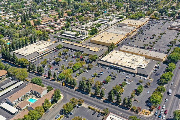 Photo of Shade Tree Plaza in Woodland, CA, is a neighborhood center anchored by Walmart Neighborhood Market and In-Shape Family Fitness.
